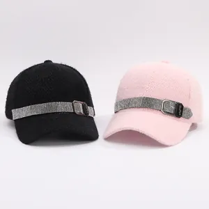 Detail of rhinestone strap and metal buckle on faux mink fur and tweed baseball caps