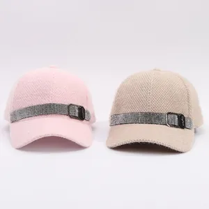 Detailed texture of knitted mink velvet baseball caps with rhinestone trim and metal buckle