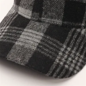 Detailed close-up of wool plaid baseball cap showing thick buffalo check fabric texture