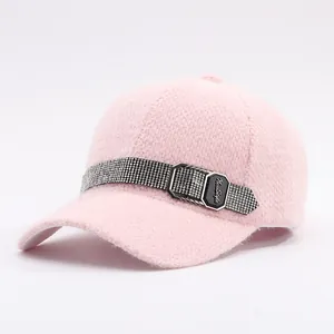 Pink faux mink baseball cap with a rhinestone-studded belt and silver metal buckle detail