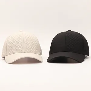 Close-up of quilted pattern texture on stylish cream and black baseball caps