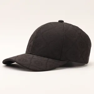 Detail of black plaid baseball cap featuring embroidered floral daisy textures