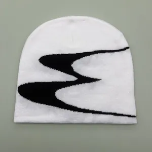 White jacquard knit beanie with black abstract pattern, cozy winter skull cap for women