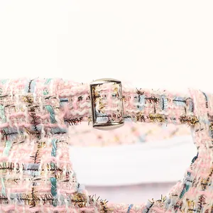 Detail of tweed baseball cap back with pink gold thread and adjustable metal buckle