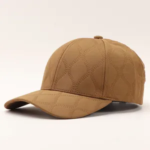 Detail view of khaki checkered baseball cap with soft quilted texture and minimalist style