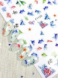 Detail of nautical nail stickers featuring watercolor goldfish, coral, and starfish designs