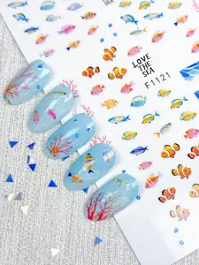 Detailed 3D nail art stickers featuring tropical fish and vibrant coral reef patterns