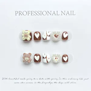 Kids cute cartoon press-on nails featuring brown teddy bears and pearl heart charms