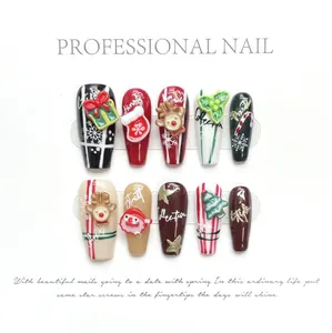 Detailed view of long ballerina press-on nails with 3D embossed Christmas deer and snowflake art