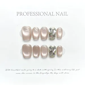 Handmade cat eye press-on nails in pink with rhinestones and gold glitter edges