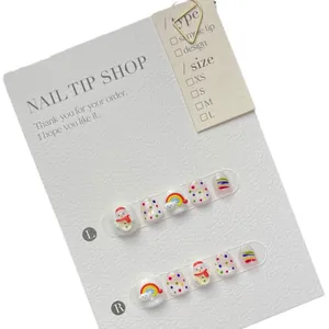 Kids press-on nails set featuring cute snowman, rainbow and colorful polka dot designs
