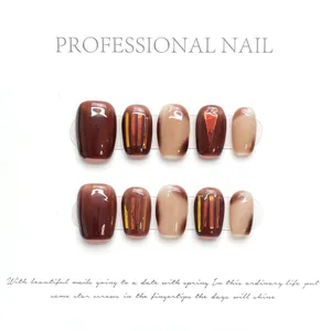 Handmade caramel brown cat-eye press-on nails with marble design and gold foil flakes