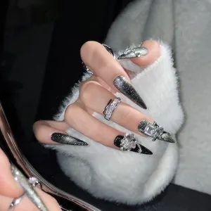 Detailed view of black cat-eye press-on nails with luxury rhinestones and crystal charms