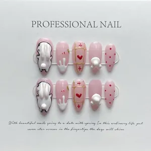 Detail of 10pcs 3D press-on nails with rabbit, heart and drip art on white card