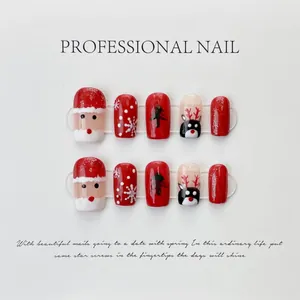 Detail of red Christmas press-on nails with Santa Claus and snowflake hand-painted patterns