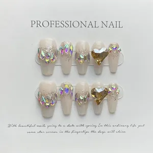 Detailed view of handmade press-on nails with shimmering laser glitter and 3D heart gems