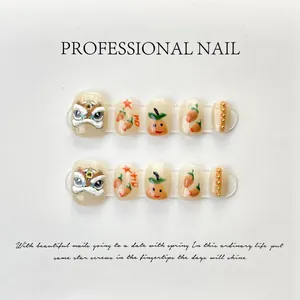 Macro detail of handmade press-on nails with 3D lion dance art and golden beads