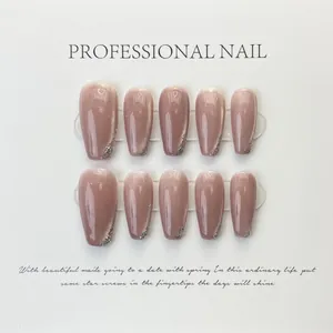 Detail of pink press-on nails with silver cat-eye finish and glitter tip in ballet shape