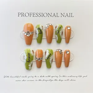 Detail of handmade coffin press-on nails with bright orange, green, and daisy design