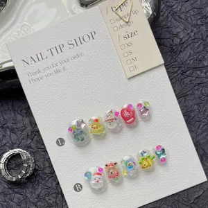 Close-up of 3D Christmas press-on nails with Santa Claus and reindeer embossed patterns