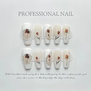 Detailed view of floral press-on nails with 3D silver outlines and rose designs