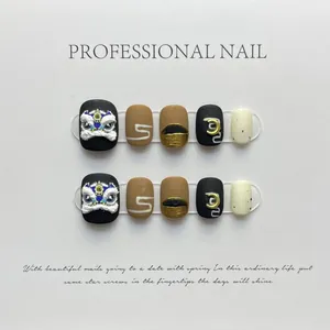 Detailed view of handmade press-on nails featuring 3D lion dance embossed design and gold foil