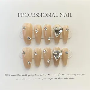 Macro shot of 10pcs nude coffin press-on nails with silver rhinestones and heart crystal
