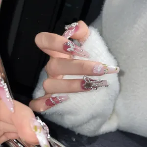Pink gradient coffin press-on nails with silver butterfly bow and 3D floral accents