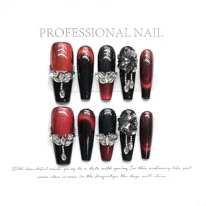 Dark red cat eye press-on nails with silver rhinestones and metal chain in coffin shape