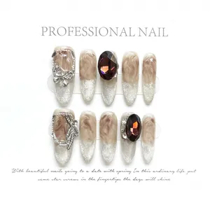 Brown marble press-on nails with silver glitter, 3D butterfly, and rhinestones