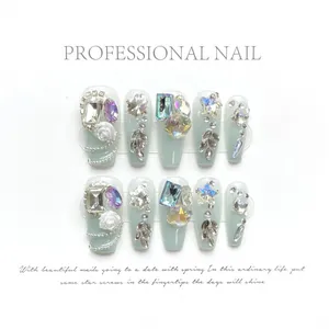 Handmade emerald green press-on nails with luxury crystal gems and floral 3D accents