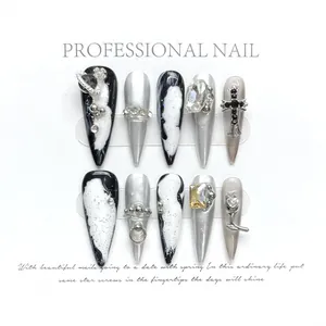 Handmade stiletto press-on nails with silver cat-eye effect and 3D metallic charms