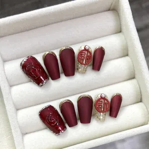 Handmade Chinese style press-on nails in burgundy with gold accents and Fu character