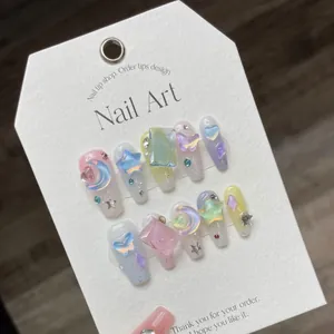 Pastel aurora press-on nails featuring 3D butterfly, stars, and moon charms on 10pc set