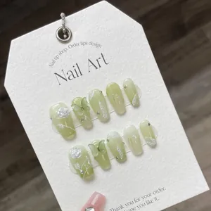 Handmade light green gradient press-on nails with 3D white roses and butterfly charms