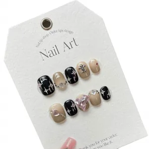 Handmade press-on nail set featuring black gradient with silver cross and rhinestones