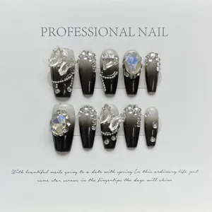 Handmade press-on nails with black and white gradient, crystals, and butterfly charms