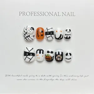 Handmade Halloween press-on nails with cute pumpkin, ghost, and mummy hand-painted designs