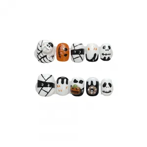 Handmade Halloween press-on nails featuring hand-painted pumpkin and ghost motifs