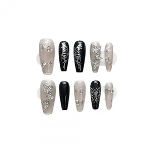 Y2K liquid silver butterfly press-on nails with black and pink gradient rhinestone design