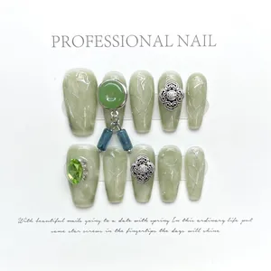 Handmade Chinese style press-on nails with green jade texture and silver metal charms