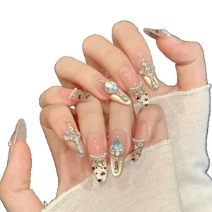 Pink leopard press-on nails with champagne cat eye finish and luxury rhinestones
