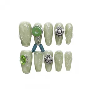 Green jade style press-on nails with silver marble texture and vintage Chinese charms