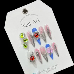 Handmade stiletto press-on nails with metal tassels, evil eye charms, and cat eye effect