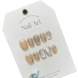 Handmade cat eye press-on nails with 3D floral relief and gold glitter accents