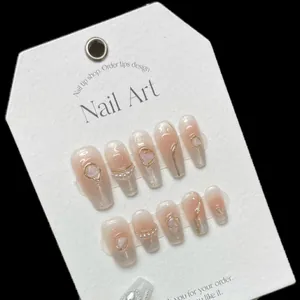 Handmade gradient pink press-on nails with silver cat-eye effect and pearl accents