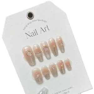 Handmade gradient pink press-on nails with pearls, silver glitter and gold-edged gems