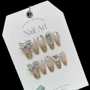 Pink and gold French handmade press-on nails with luxury rhinestones and silver bow
