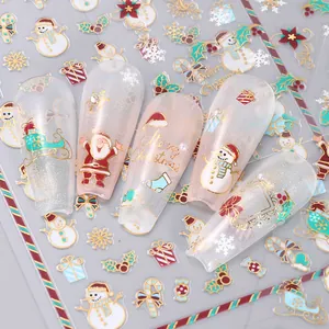 Detail of Christmas nail stickers with gold foil Santa, reindeer and snowflake patterns