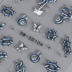 Macro detail of 5D embossed nail stickers featuring silver Y2K butterfly and chain patterns